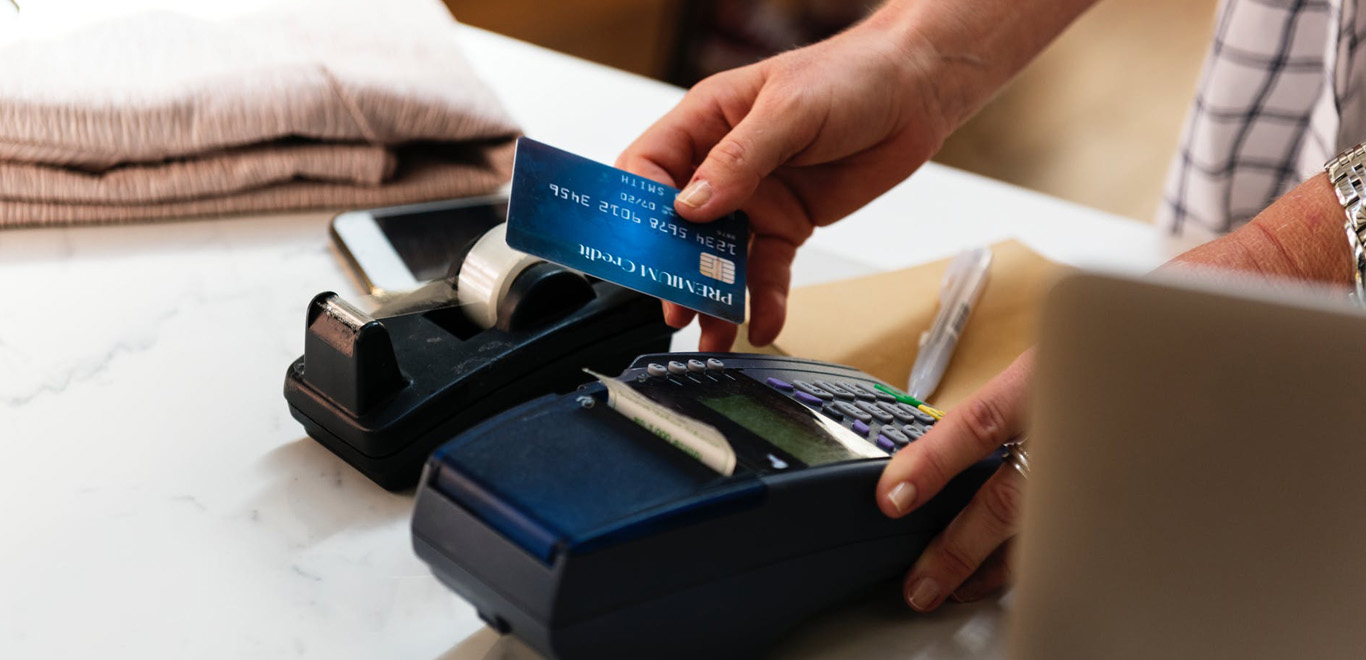 Customer paying by card at the counter